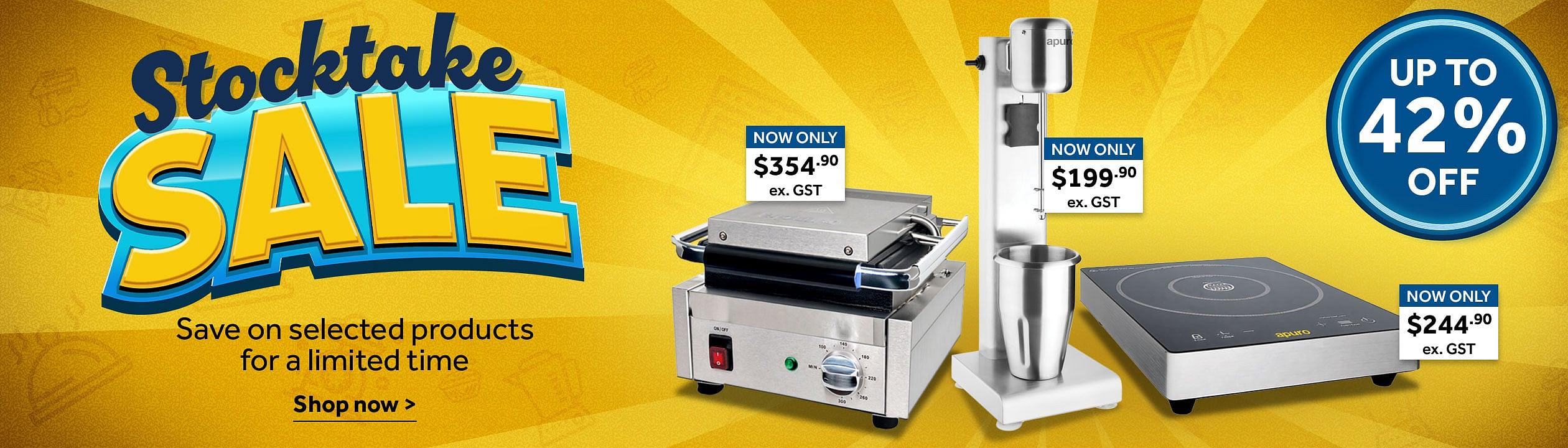 Stock Take Sale. Stocktake Sale promotional banner on a yellow background featuring discounted commercial kitchen equipment. Large text reads 'Stocktake SALE' with 'Save on selected products for a limited time' and 'Shop now'. Products shown include a panini grill priced at $354.90 ex. GST, a stick blender priced at $199.90 ex. GST, and an induction cooktop priced at $244.90 ex. GST. A blue badge on the right states 'Up to 42% off. Shop now >