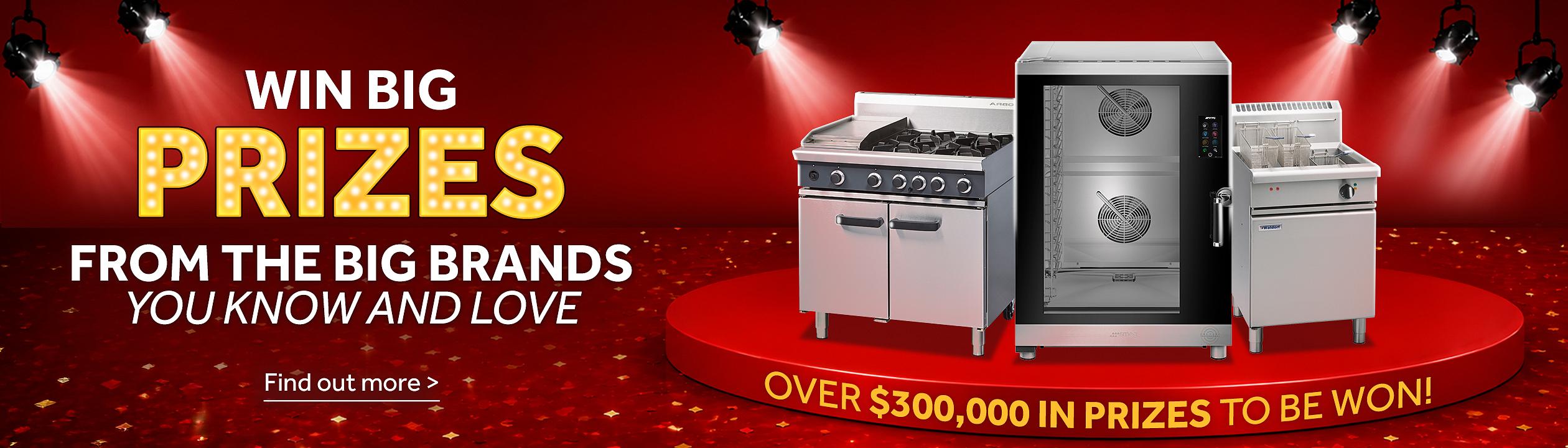 Promotional prize giveaway banner with the headline “WIN BIG PRIZES FROM THE BIG BRANDS YOU KNOW AND LOVE” on a red background. Three commercial catering appliances, including a gas range, combi oven, and fryer, are displayed on a spotlighted podium. Text highlights “OVER $300,000 IN PRIZES TO BE WON!” with a “Find out more” call to action at the bottom. Find out more >