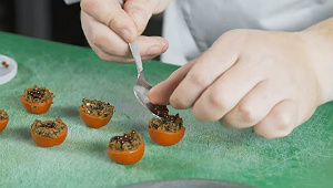 Top the olive caviar with the balsamic pearls