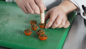 Fill the tomato cups with the caviar mixture and make an indent in the top