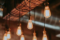 Rows Of Swtiched-On Light Bulbs Which Can Consume Huge Amounts Of Energy