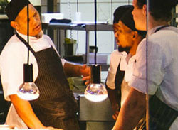 A Kitchen Staff Member Engaging With His Team To Pass On The Eco Message And Communicate Your Sustainablity Goals