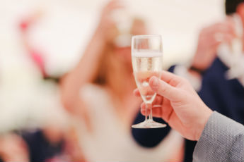 A man raising a champagne glass How to Convert a Horsebox article