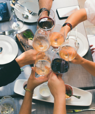 Wine glasses being raised together with hands How to Store & Care for Glassware article