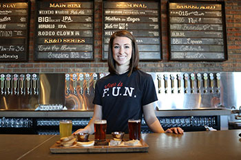 Hospitality worker smiling while serving food